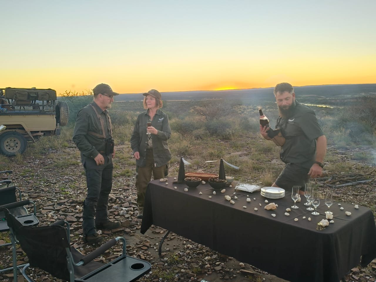 Drinks poured at a sundowner above the river