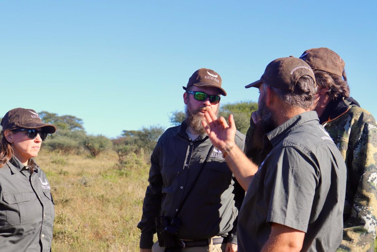 A professional hunter briefs guests before heading out