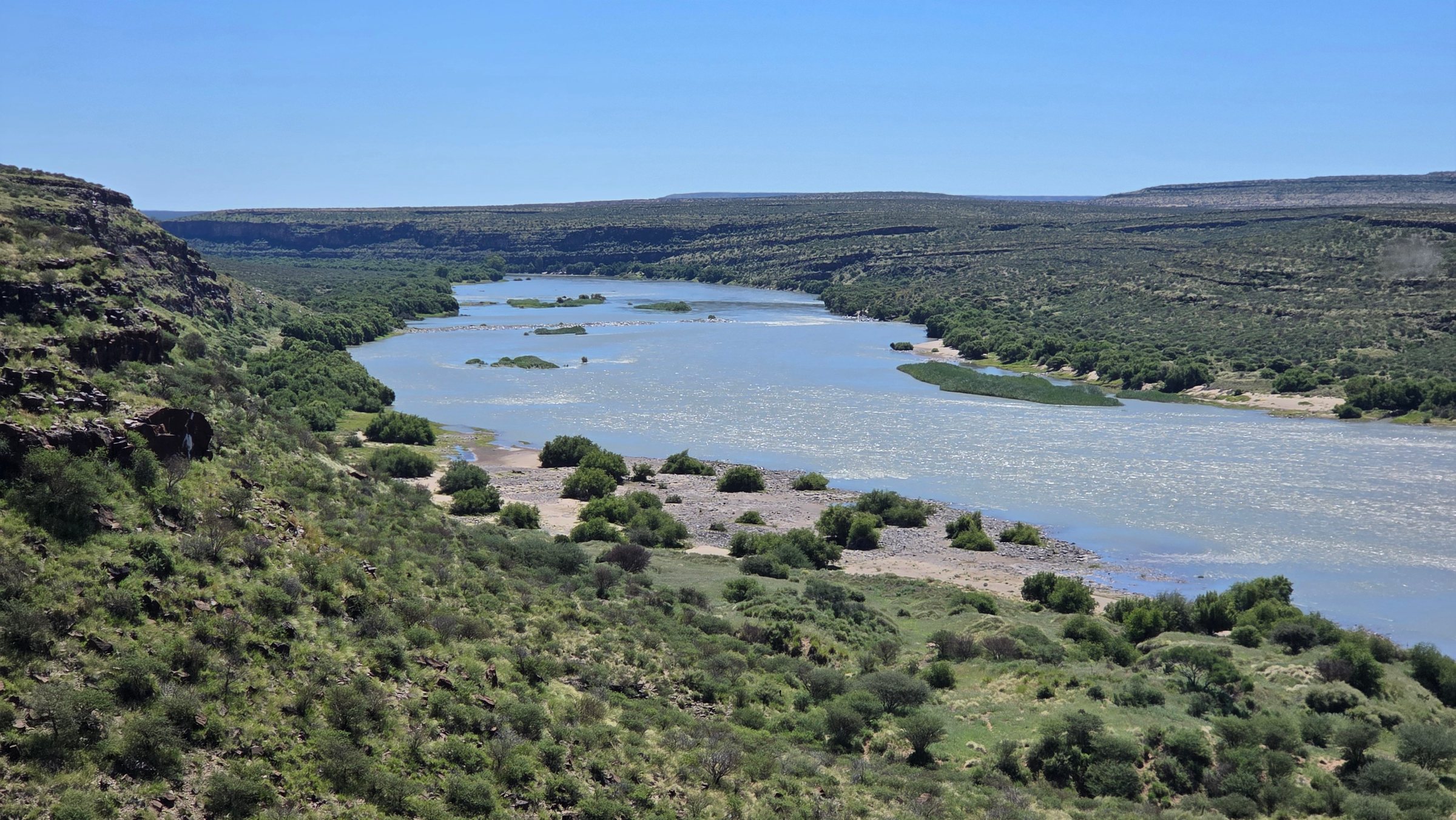 The river winds through a green gorge