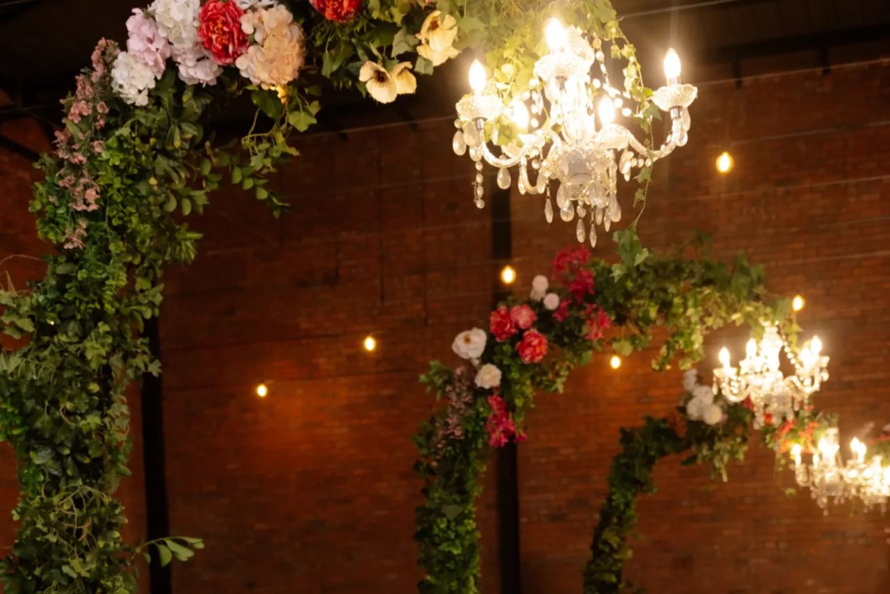 A floral arch with chandeliers